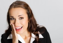 Businesswoman covering mouth, over gray
